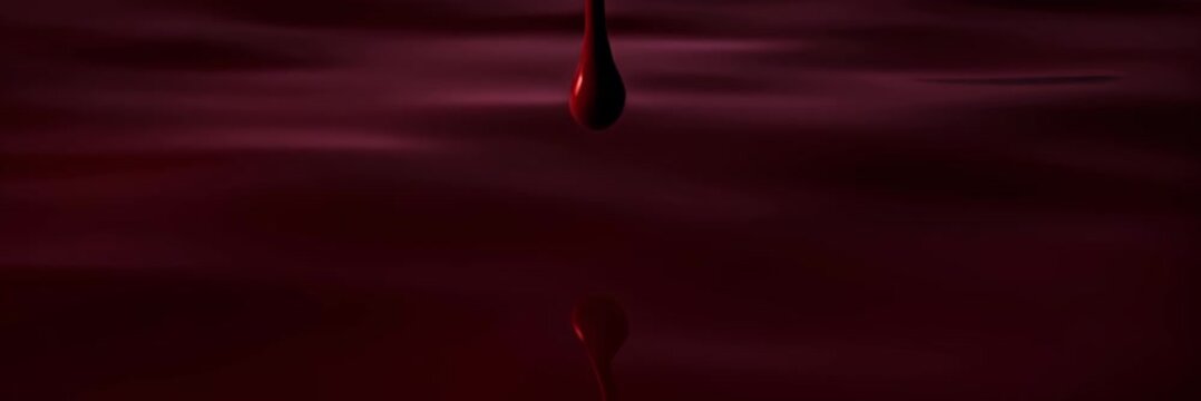 Red liquid drop resembling blood falling in dark wide website banner format with copy space, halloween concept, horror scene, dramatic minimal background.