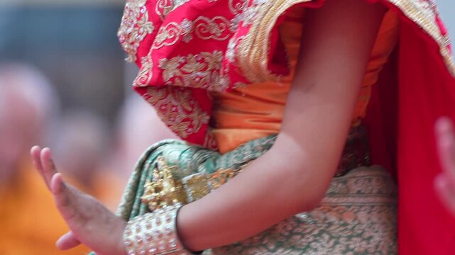 Traditional Thai dance close perspective focusing on expressive hand and foot gestures with intricate costume details and cultural performance style.