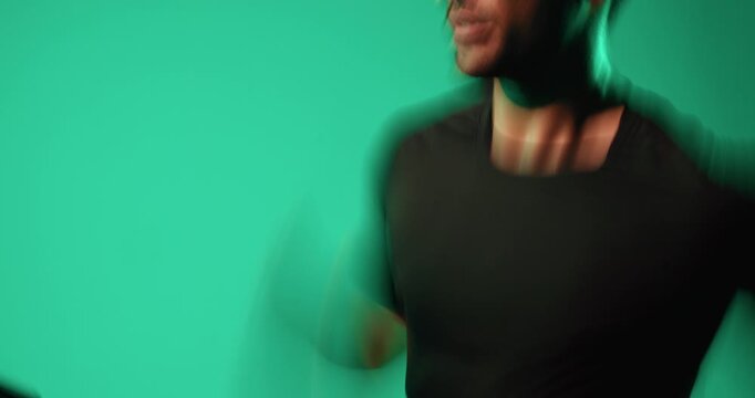 Treadmill, running and man in studio for training, fitness and fast runner on green background. Cardio machine, speed and person exercise for health, motion blur and sprint to workout for wellness