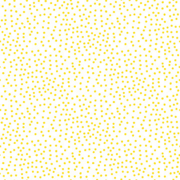 Polka dot seamless pattern with scattered yellow dots on white background. Summer dot tile in cute hand drawn naive motif for allover print. Abstract polka vector repeat with vintage grain.