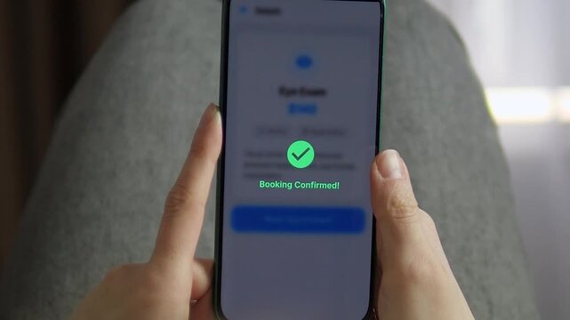 Close-up of a person booking an eye exam via a high-tech medical app. Smooth UI transitions from service details to loading and successful confirmation. Perfect for medtech, telehealth, and modern