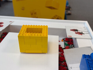 Fototapeta premium Yellow hollow lego cube on display