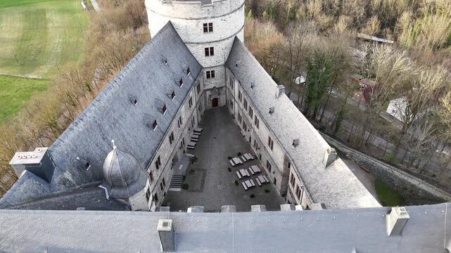 Drone moves forward and upward above the inner section while tilting down to reveal the courtyard.