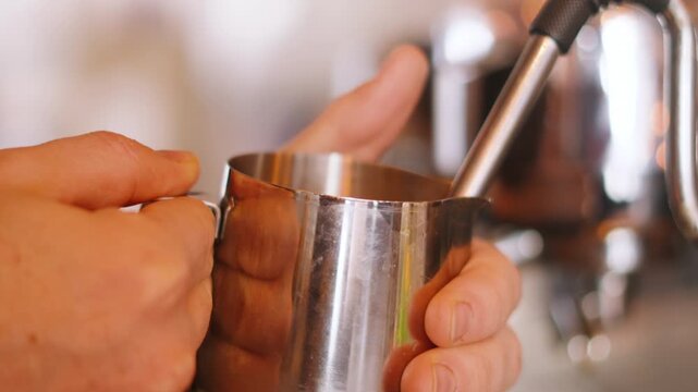 Close-up of Barista Using Milk Frother to Make Flat White Coffee on Industrial Espresso Machine. Independent Cafe Restaurant Clip.