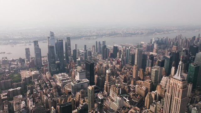 Drone overlooking the Midtown West skyline and Hudson Yards, hazy day in NYC