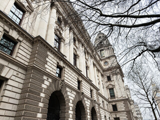 Naklejka premium Historic neoclassical HM Treasury government building facade with columns and tower in London, UK