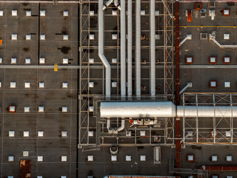 Aerial view of a textured industrial rooftop with pipes and structures creating a geometric pattern, Atessa, Abruzzo, Italy.