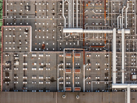 Aerial view of a complex rooftop labyrinth of pipes and vents creating a textured industrial landscape, Atessa, Abruzzo, Italy.