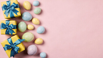 Obraz premium Pastel Celebration: Gifts and Decorative Eggs on Pink Background Copy Space