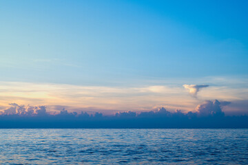 Fototapeta premium Minimalist seascape of the Pacific Ocean off Lanyu, Taiwan - Beautiful gradient sky and clouds over the horizon.