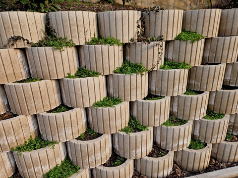 hollow concrete retaining wall system, often referred to as plantable living retaining wall blocks. clever way to manage slopes while avoiding look of solid, imposing concrete slab. Erosion Control 