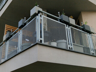 Fototapeta premium modern balcony railing with expanded metal infill. This type of infill is popular in architecture for its combination of safety, airiness and ability to provide privacy without completely blocking the