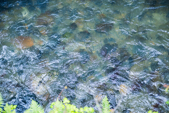 Stone texture under clear flowing river water in Japan