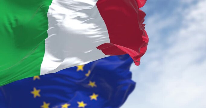 Italy and European Union flags waving on a clear day
