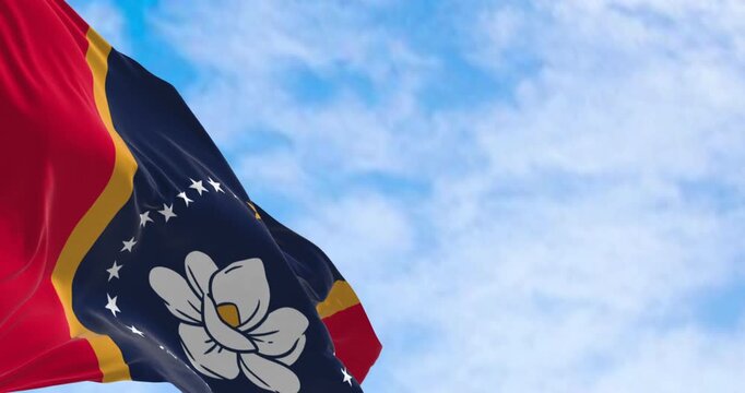Mississippi state flag waving on a clear day