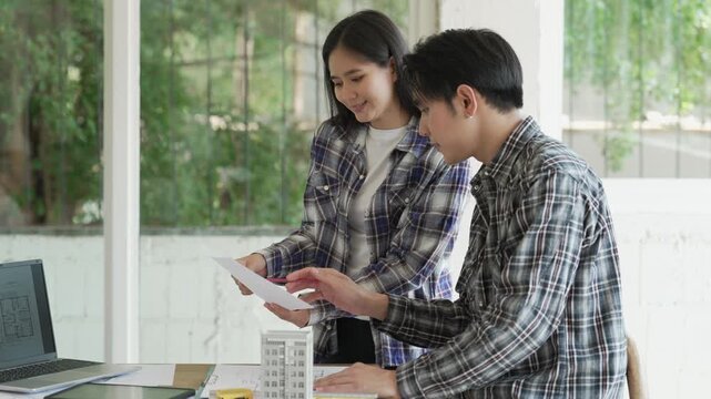 Engineers, architects, and technicians are analyzing structural design drafts in meetings with tabletop blueprints and discussing the project collaboratively in office meetings.