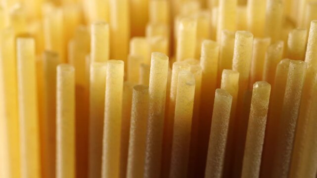 Macro of dry spaghetti pasta, dolly shot, texture, close-up.