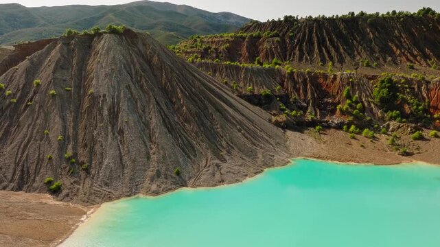 Turquoise mineral lake in abandoned quarry aerial drone Evia Greece