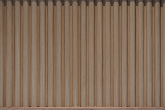 Vertical fluted wood panel texture. Modern interior wall cladding with light brown wooden slats in a seamless pattern.