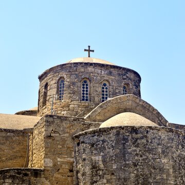 Circular Stone Drum and Cross of Saint Barnabas Church and Monastery Under Clear Blue Sky, North Cyprus