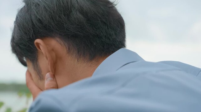 Disappointed and confused male office worker crying alone outdoors stress and burnout for work tired, feeling disappointed and overwhelmed by emotions of job loss and financial problems