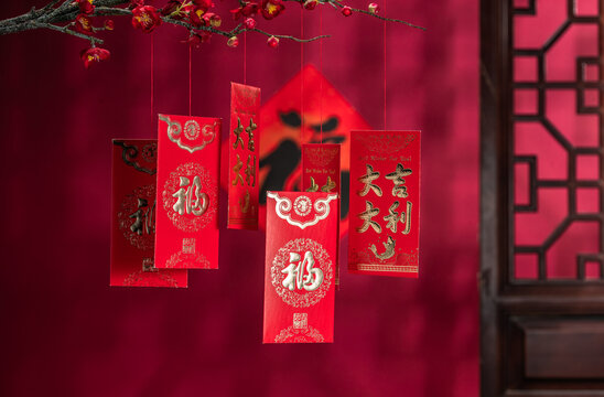 Traditional Red Packets with Kanji Underneath Plum Blossoms