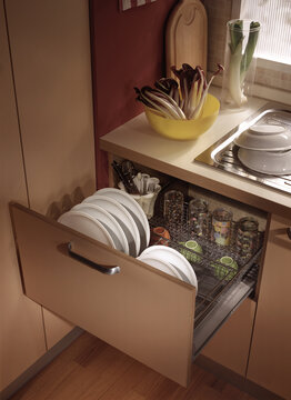 Close up of a kitchen cabinet with drawers and baskets