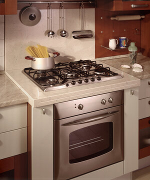 Close up of a kitchen cabinet with a steel hob
