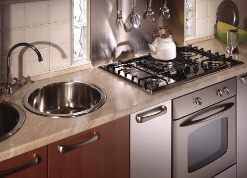 Close up of a kitchen cabinet with a steel hob