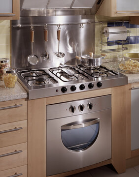 Close up of a kitchen cabinet with a steel hob