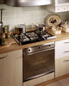 Close up of a kitchen cabinet with a steel hob