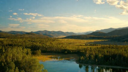 Fototapeta premium Wide valley with river and distant mountain ranges at sunset