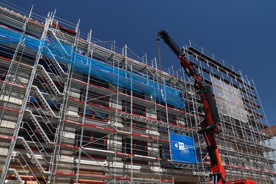 NUREMBERG, GERMANY - MAY 7, 2018: Construction site in downtown Nuremberg, Germany. The big loading crane is Palfinger model PK 20000 2L.