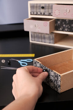 Hand decorating a DIY wooden drawer unit