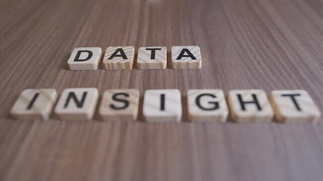 "Cinematic focus shifts between the wooden words DATA and INSIGHT on a rustic background."