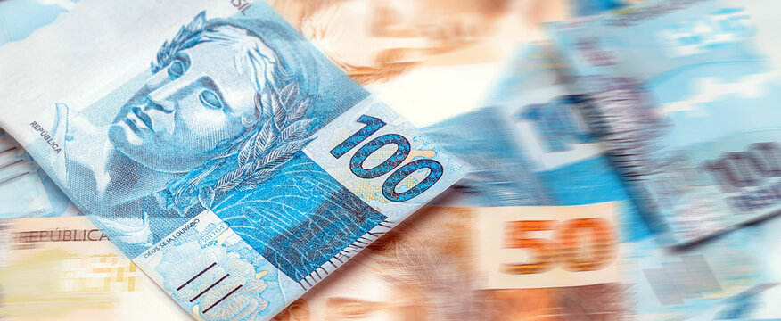 Brazilian money, in pinpoint focus, one hundred reais banknotes for journalistic background or promotions, concept of jackpot, draw or payment