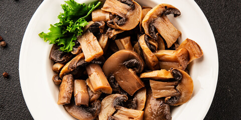 Fototapeta premium Champignon mushrooms ready to eat tasty snack fresh gourmet food background on the table rustic food top view copy space keto and paleo diet vegetarian and vegan food marketing concept photo