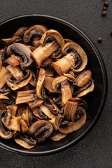 Fototapeta premium Champignon mushrooms ready to eat tasty snack fresh gourmet food background on the table rustic food top view copy space keto and paleo diet vegetarian and vegan food marketing concept photo
