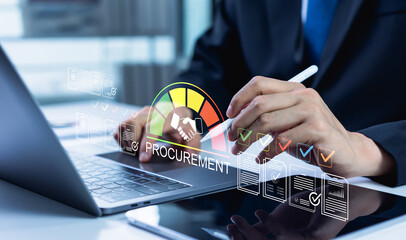 Businessman manages a digital procurement process on a laptop and tablet, reviewing a supplier...