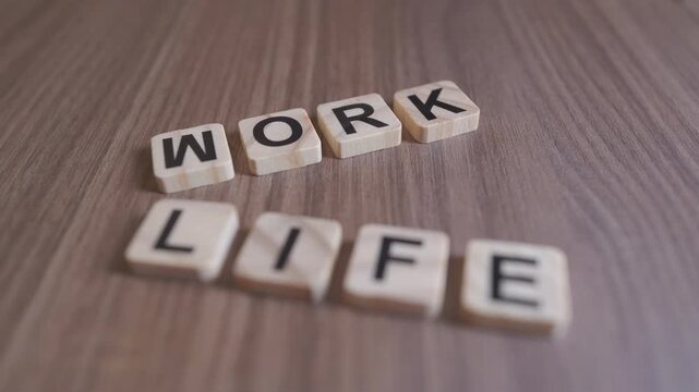 "Cinematic focus shifts between the wooden words WORK and LIFE on a rustic background."