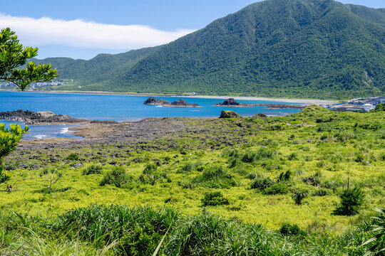 Lanyu, Taiwan: Panoramic view of lush green mountains and Pacific coastline on volcanic island.