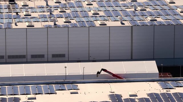 Solar panels installation on industrial building rooftop