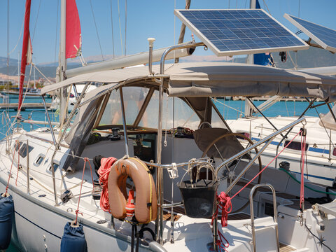 Modern sailing boat features solar panel system on deck for sustainable power supply. Renewable energy technology provides electricity for yacht systems during long sea voyages in Turkey.
