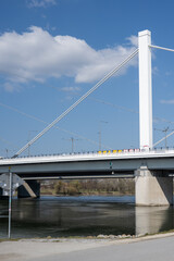 Obraz premium bridge crossing the danube in Linz, Austria with hills in the background und sky with white clouds