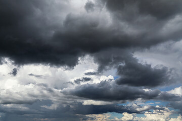 Fototapeta premium Stormy cloudy dramatic sky with dark rain thunderstorm cumulus clouds background texture