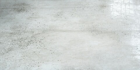 Fototapeta premium Concrete floor shows wear, texture. Light reflects off surface, creating subtle patterns. Minimalist aesthetic, industrial feel.