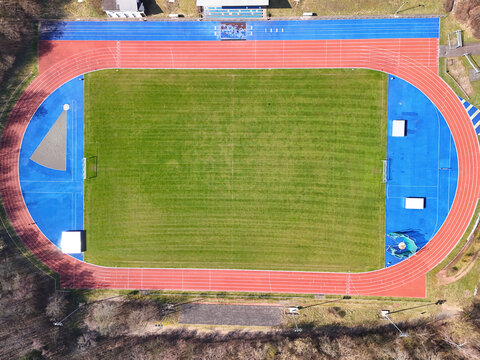 Aerial View of Sports Facility with Running Track and Multi-Sport Courts	
