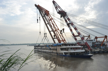 Fototapeta premium Industrial Cranes Lifting Sunken Passenger Ship Rescue Operation