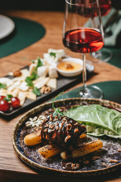 Luxury restaurant composition with meat dish, red wine and cheese platter. Elegant fine dining concept perfect for gastronomy, wine pairing, restaurant promotion and premium food photography.