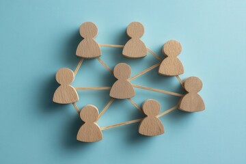 Obraz premium Human Network: A network of wooden figures connected by lines on a blue backdrop, symbolizing collaboration and community.